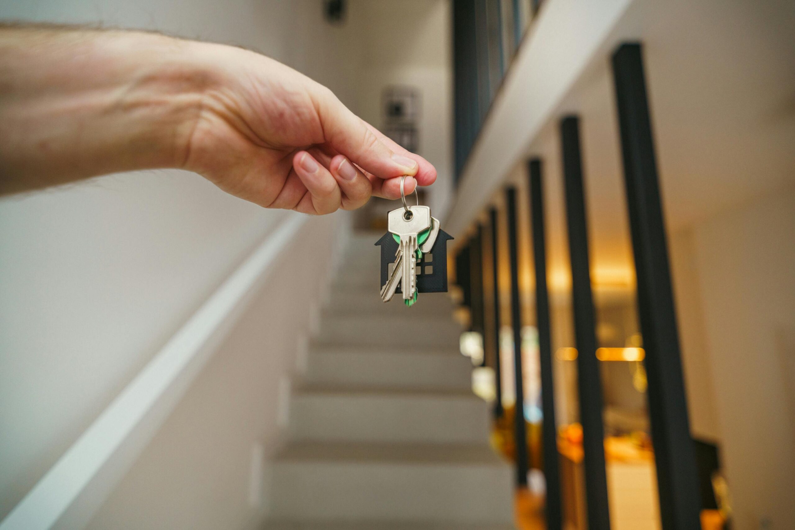 Close-up of person holding keys to new apartment