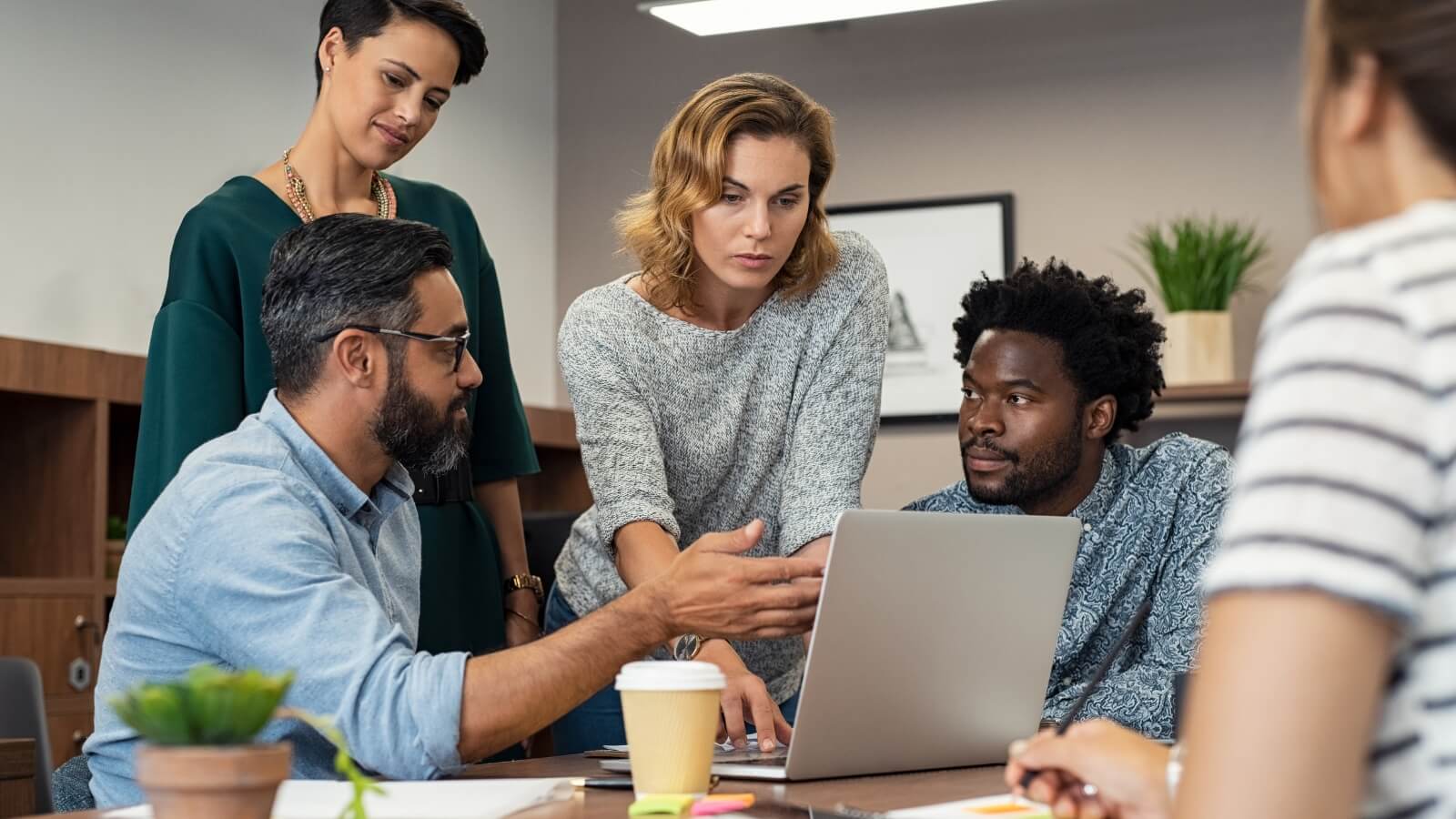 Corporate travelers and digital nomads collaborating in a modern Barcelona apartment setting.