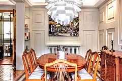 In the dining area, the classy mahogany table and chairs stand out under the massive Artichoke lamp