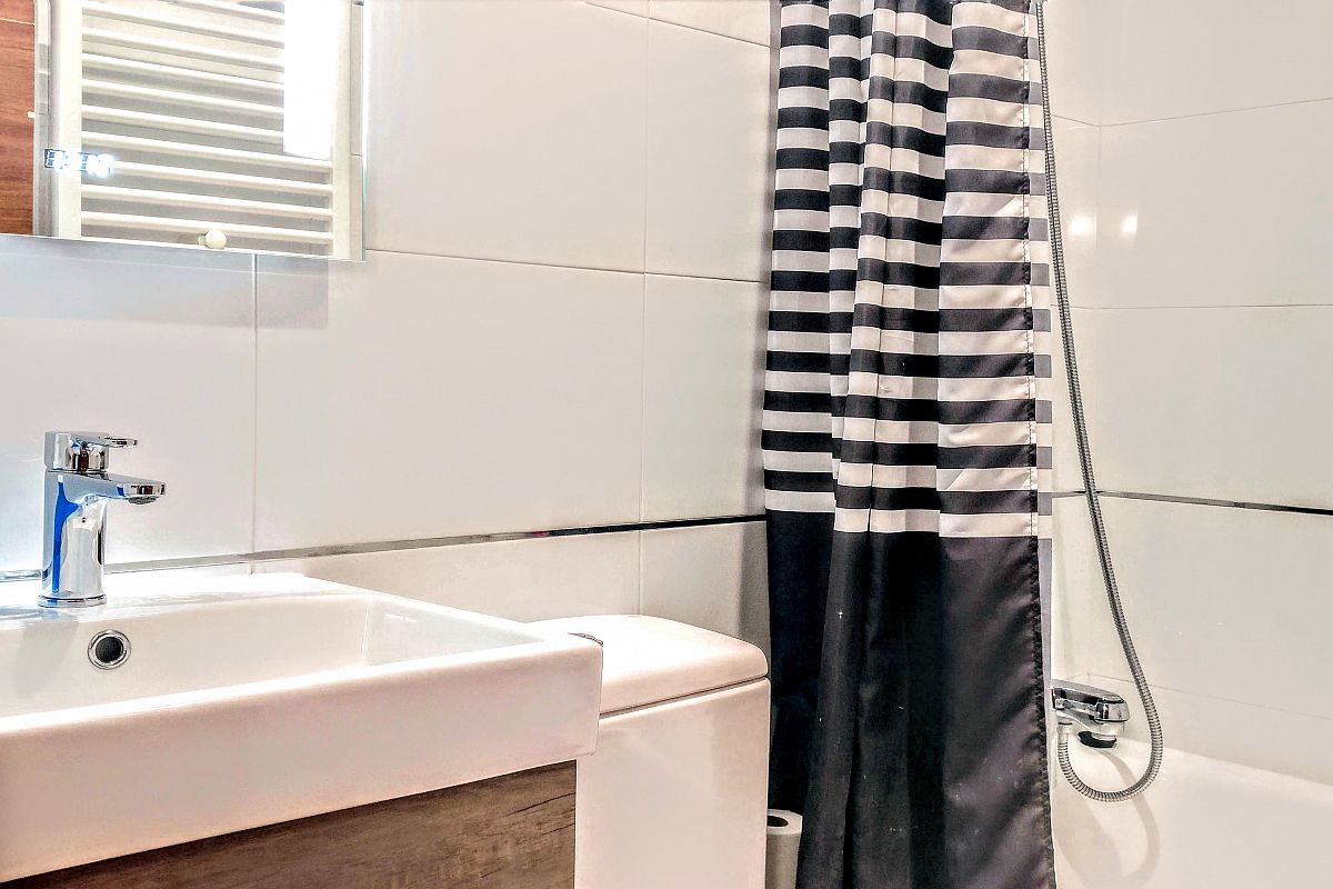 full bathroom with a modern look and heated towel rail