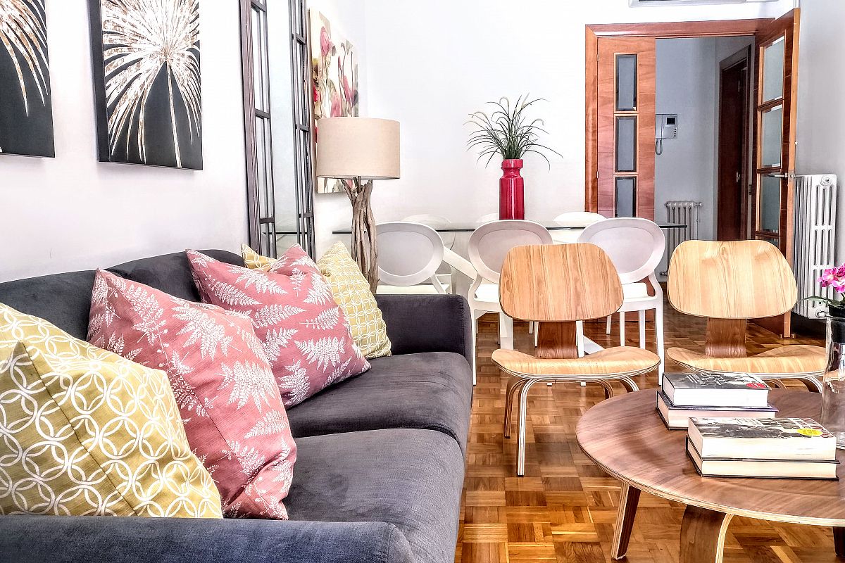 the living area with this comfortable sofa and designer chairs at the Noname apartment is very convenient for family trips to Barcelona during your short term rental stay