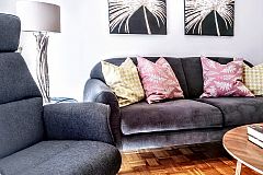 settle into the living area’s lush and comfortable sofa to watch television or talk with your friends