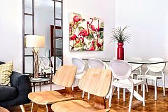 the dramatic flamingos painting is the main focal point in the sleek dining area of the Noname property with terrace in Barcelona in the Eixample area