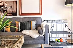 beautiful sofa corner with pictures composition, side tables and rattan table