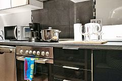 sleek cabinetry and stainless steel apliances are included in this fully equiped kitchen