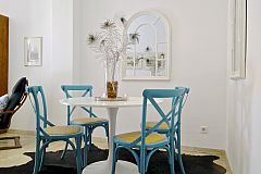 detail of the dining area with the lovely blue chairs and a pair of mirrors