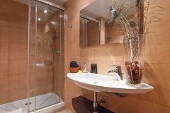general view of the bathroom with shower cabin and designer washbasin