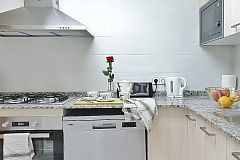 the Kitchen, a clean, fully fitted kitchen with all utensils, dishwasher and washer