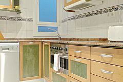 general view of the kitchen in the Macca apartment with balcony in Barcelona with oven and dishwasher