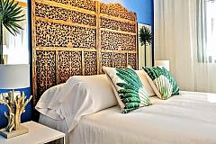 dradramatic wooden headboard fitting to perfection the bed cushions, bed lamps and that tropical vibe filling the ambiencematic fabric headboards fitting to perfection the bed cushions and plaids