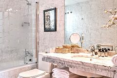 master ensuite bathroom in white marble with bathtub