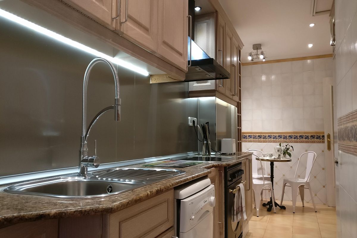 LED strips under the cabinets in the private kitchen at ahe Gatsby  apartment in Les Corts with terrace near Diagonal avenue