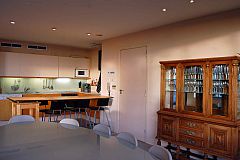 the ground floor has a dinning room with table suitable for ten people and it is connected to the kitchen through a bar in this Villa for rent in Sitges