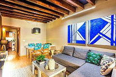 blue paintings define the warm character of this apartment ideal for corporate stays in Barcelona